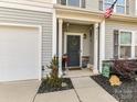 Inviting front porch with columns, decorative accents and a green wreath on the front door at 2437 Grinstead Ct, Clover, SC 29710