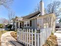 This beautiful home boasts classic design, a stone chimney and a white picket fence enhancing its curb appeal at 2919 Park Rd, Charlotte, NC 28209