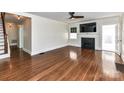 A spacious living room featuring a fireplace, hardwood floors, and a ceiling fan at 2919 Park Rd, Charlotte, NC 28209