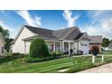 Well-maintained home with manicured lawn, front porch seating, and charming architectural details at 313 Garner Dr, Salisbury, NC 28146