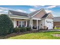 Charming single-story home with a welcoming front porch and well-maintained landscaping at 313 Garner Dr, Salisbury, NC 28146