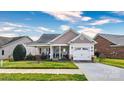 Inviting single-story home with a covered front porch and manicured lawn at 313 Garner Dr, Salisbury, NC 28146