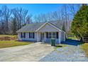 Exterior view of a home featuring a well-manicured lawn and a classic front porch at 3345 Hunting Wood Ct, Gastonia, NC 28052