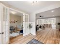 Bright, open-concept living space featuring light-colored hardwood floors and an adjacent office space at 388 Speedway Nw Pl # 1, Concord, NC 28027