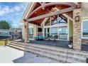 Covered patio with stone pillars, lake view, and outdoor seating area at 5086 Windward Point Ln, Denver, NC 28037