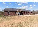 A lovely brick house features a durable metal roof, complemented by a well-kept lawn and inviting curb appeal at 515 Panhandle Rd, Gold Hill, NC 28071