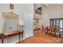 Dining room with wood floors, wainscotting, large mirror, and view of the 2nd story loft at 5213 Wood Lake Dr, Belmont, NC 28012