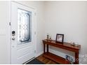 Welcoming foyer with a decorative glass door, wood floors, and console table at 5341 Orchid Bloom Dr # 55, Fort Mill, SC 29707