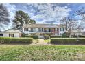 Charming two-story exterior showcasing manicured lawn, mature trees, and inviting facade at 7101 Quail Meadow Ln, Charlotte, NC 28210