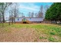 Spacious fenced backyard with a lawn and a wooden deck, perfect for outdoor entertaining at 80 Sunset Dr, Taylorsville, NC 28681