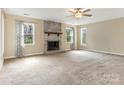 Spacious living room with a striking brick fireplace and ample natural light at 8101 Coxwood Ct, Charlotte, NC 28227