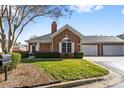 Charming brick home featuring a well-kept lawn, attached garage, and a traditional design at 8328 Highland Glen Dr, Charlotte, NC 28269