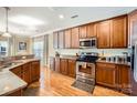 Kitchen featuring wooden cabinets, granite countertops and stainless steel appliances at 8436 Summerford Dr, Charlotte, NC 28269