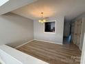 Dining room featuring wood floors, chandelier and pass through to kitchen at 9037 J M Keynes Dr, Charlotte, NC 28262