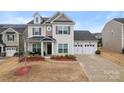 Charming two-story home with a multi-car garage and tidy landscaping at 966 Parkland Nw Pl, Concord, NC 28027