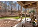 Relaxing covered front porch, featuring columns and decorative stone at 109 Hawksnest Ln, Mooresville, NC 28117