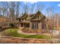 A picturesque home with a stone facade and professionally landscaped front yard at 109 Hawksnest Ln, Mooresville, NC 28117