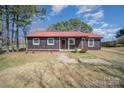 Charming home featuring a red roof, brown siding, and a stone pathway leading to the front door at 127 Barry Oak Rd, Statesville, NC 28625