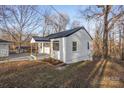 Cozy one-story house featuring a covered porch and beautifully landscaped yard in a serene setting at 1605 5Th St, Statesville, NC 28625