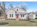 Charming home with neutral siding, a cozy front porch, and a well-manicured lawn at 1817 S Mint St, Charlotte, NC 28203