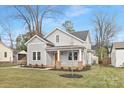 Charming home with neutral siding, a cozy front porch, and a well-manicured lawn at 1817 S Mint St, Charlotte, NC 28203