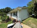 Side view of a single-story home featuring light siding and a red roof at 2027 Downey St, Rock Hill, SC 29732