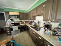 This kitchen features tile floor, brown cabinets, a double basin sink, and modern appliances at 2027 Downey St, Rock Hill, SC 29732