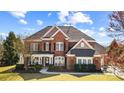 Beautiful two-story brick home showcasing a well-maintained front yard and classic architecture at 2205 Meleto Dr, Waxhaw, NC 28173