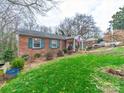 Charming brick home with green shutters and a spacious lawn at 3021 Whitson Rd, Gastonia, NC 28054