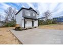 Spacious driveway leading to a modern two-story home with a charming front porch at 320 Cabarrus W Ave, Concord, NC 28025