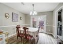 Dining room with neutral walls, and double doors providing natural light and access to outdoor area at 3224 Heathstead Pl, Charlotte, NC 28210