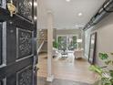 Inviting entryway view to the spacious living room featuring stairs and natural light at 3504 Colony Rd # R, Charlotte, NC 28211