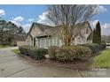 Charming home with stone accents, neat landscaping, and a curved driveway at 4709 Polo Gate Blvd, Charlotte, NC 28216