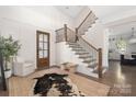 Elegant foyer with a wooden door, beautiful staircase, and stylish decor at 5608 Closeburn Rd, Charlotte, NC 28210