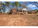 A side view of a well-maintained brick house with an adjacent carport at 571 Amity Se Ave, Concord, NC 28025