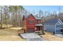 Charming two-story home with a well-manicured front yard and a one-car garage at 607 W Stanly St, Stanfield, NC 28163