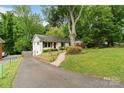 Inviting exterior view of the home with a paved driveway and a lush green lawn at 6126 Netherwood Dr, Charlotte, NC 28210