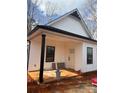 Inviting view of home showcasing a covered porch, white siding, and dark trim at 625 Academy St, Cleveland, NC 27013