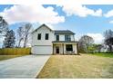 Charming new construction home with a two-car garage, a large driveway, and a covered front porch at 9615 Riviera Dr, Sherrills Ford, NC 28673