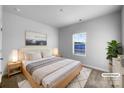 A clean bedroom featuring neutral décor, a large window, and soft carpet at 9819 Festival Way, Charlotte, NC 28215