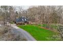 Aerial view of the brick home with large lawn and paved driveways at 1135 Ben Black Rd, Midland, NC 28107