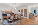 Bright dining room features hardwood floors, decorative doors, and chandelier at 1135 Ben Black Rd, Midland, NC 28107