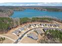 Aerial view of houses near a lake, surrounded by trees and blue skies at 1300 Dali Blvd, Mount Holly, NC 28120