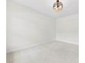 Bright, carpeted bedroom with a modern light fixture and neutral walls at 1300 Dali Blvd, Mount Holly, NC 28120