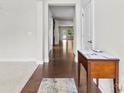 Bright hallway with hardwood floors leading to an open living space and backyard view at 1300 Dali Blvd, Mount Holly, NC 28120