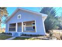 Exterior view of the home with a covered porch, updated gray siding, and trimmed landscaping at 155 31St Sw St, Hickory, NC 28602