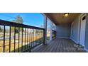 Covered front porch with a wood ceiling and floor, black railings, and bright, natural light at 155 31St Sw St, Hickory, NC 28602