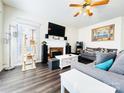 Cozy living room featuring a fireplace, large TV, and comfortable seating at 1743 Park Grove Nw Pl, Concord, NC 28027