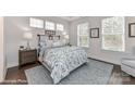 Comfortable bedroom featuring soft lighting, neutral colors, and ample natural light from multiple windows at 208 Wesser St # 8, Davidson, NC 28036