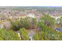 Aerial view of a beautiful neighborhood with houses near a lake and surrounded by lush greenery at 220 Kenway Loop # 41, Mooresville, NC 28117